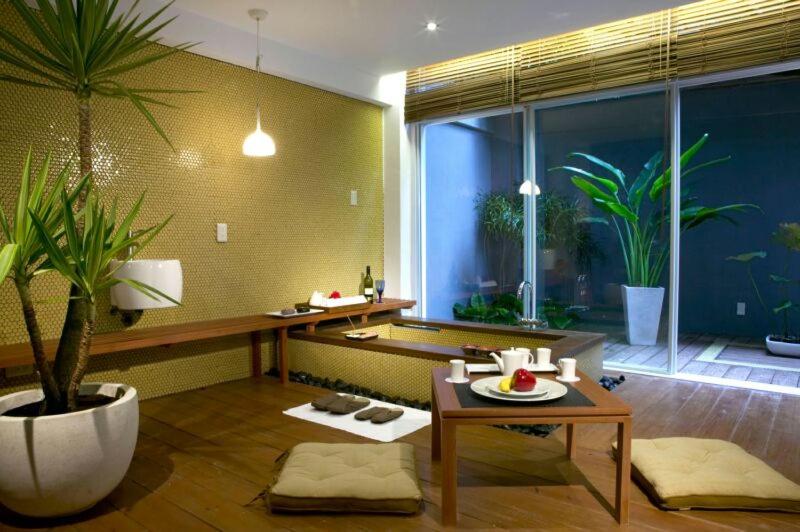 a living room with a table and a potted plant at Hotel Double One in Taipei