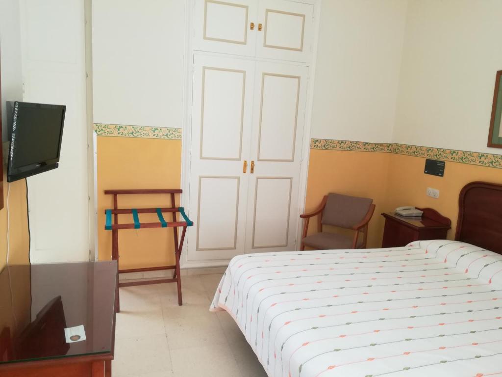 TV a/nebo společenská místnost v ubytování Nuevo Hotel