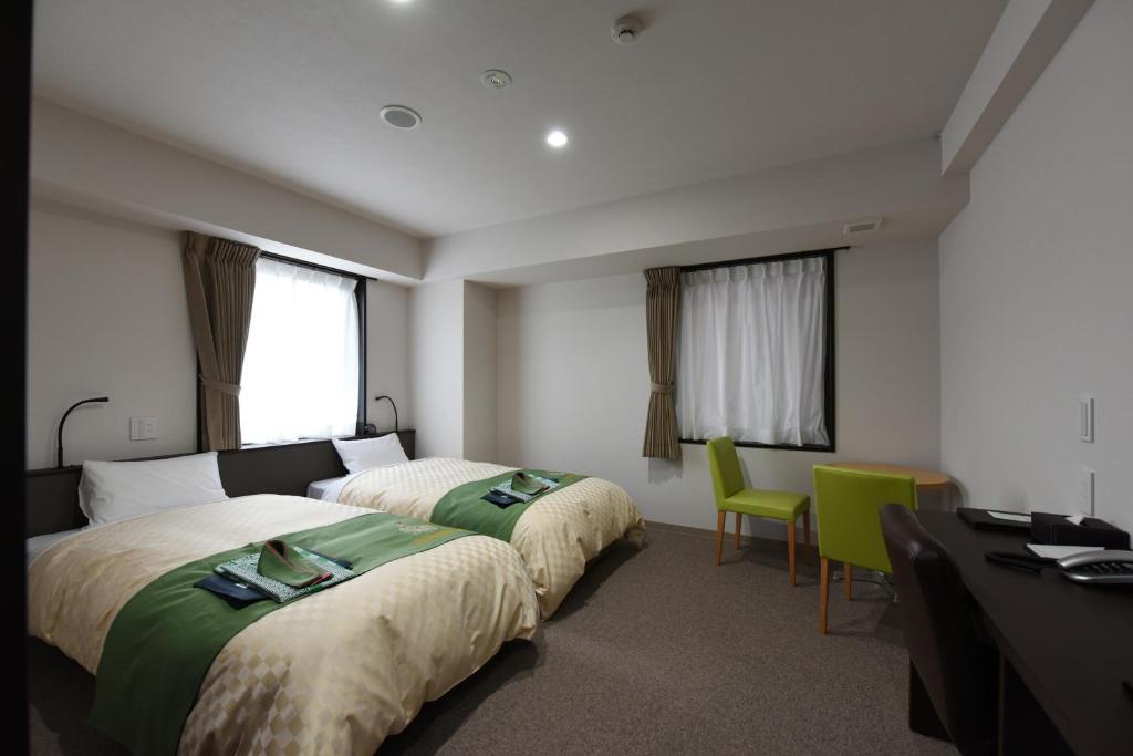 Postel nebo postele na pokoji v ubytování Hotel Showmeikan