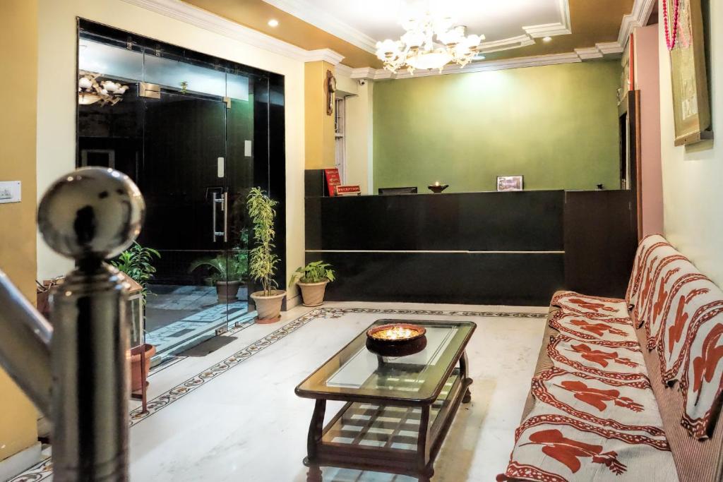 a living room with a couch and a table at Hotel Laxmi Palace in Udaipur