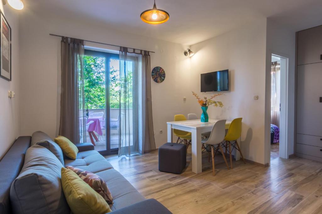 a living room with a couch and a table at Apartments Sun in Zadar