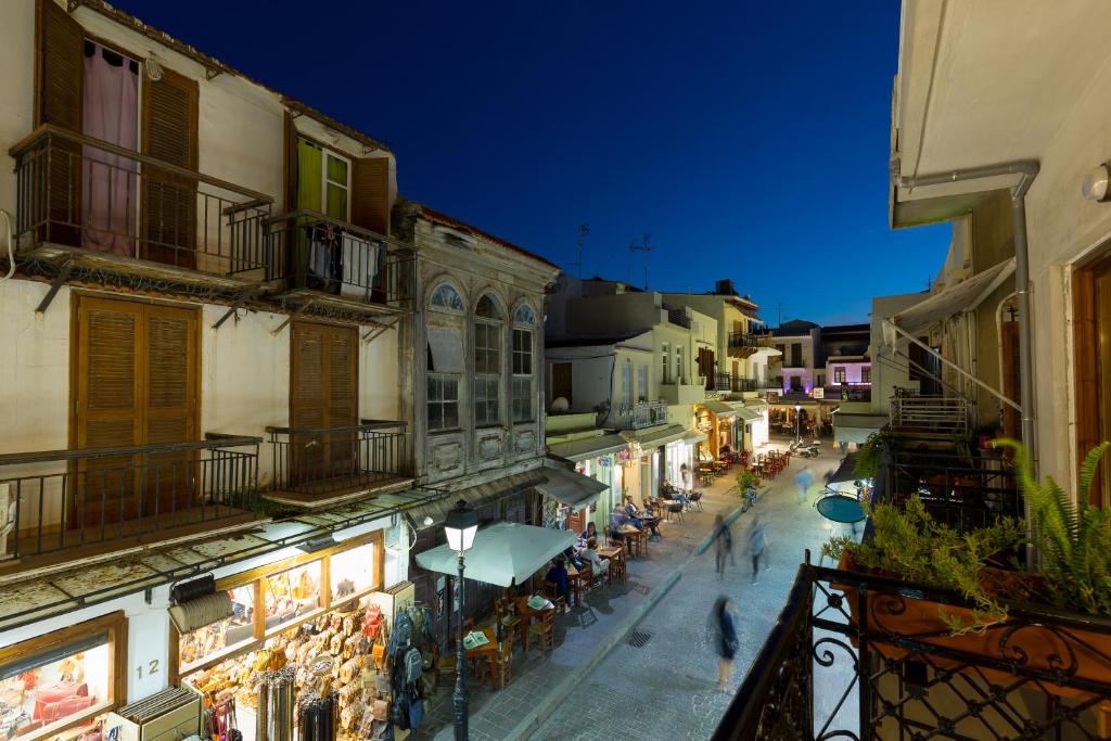 a group of people walking down a street at night at Loggia Ηome in Rethymno Town