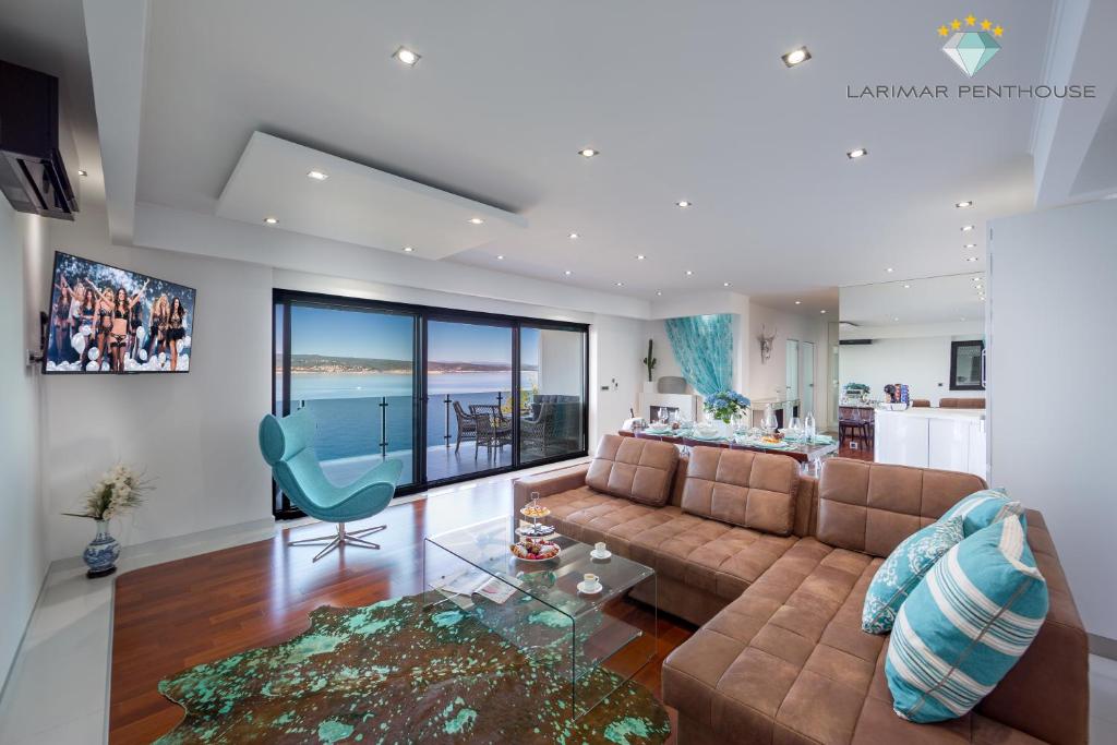 ein Wohnzimmer mit einem Sofa und einem Glastisch in der Unterkunft Larimar Penthouse in Crikvenica