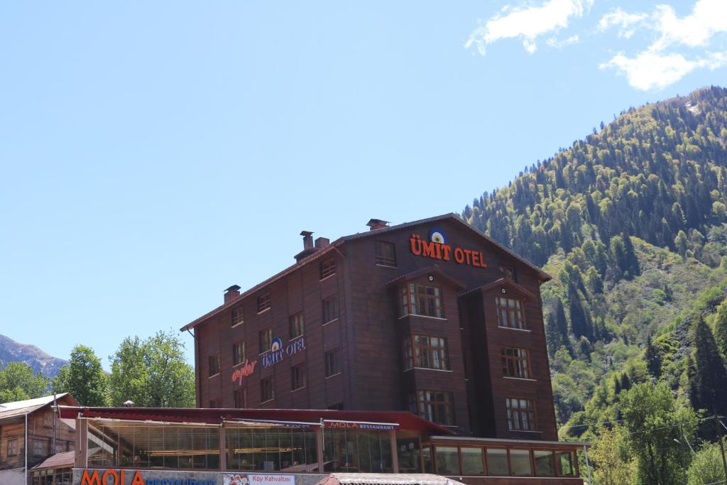 a large brown building with a sign on it at Ayder Umit Hotel in Ayder Yaylasi