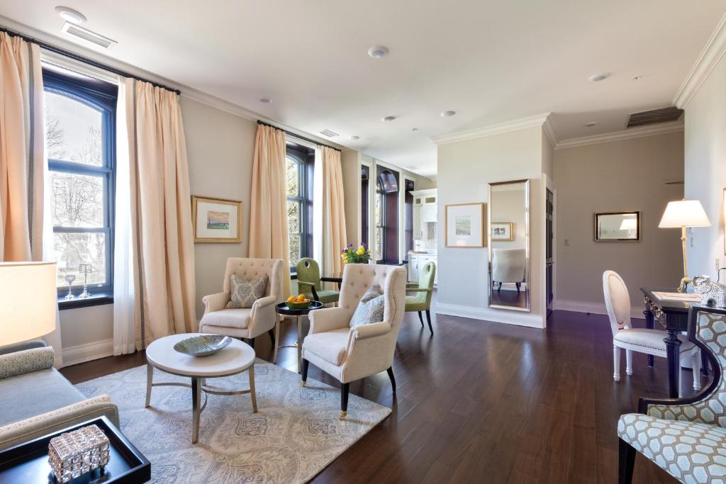 a living room with chairs and a table at Sydney Boutique Inn & Suites in Charlottetown