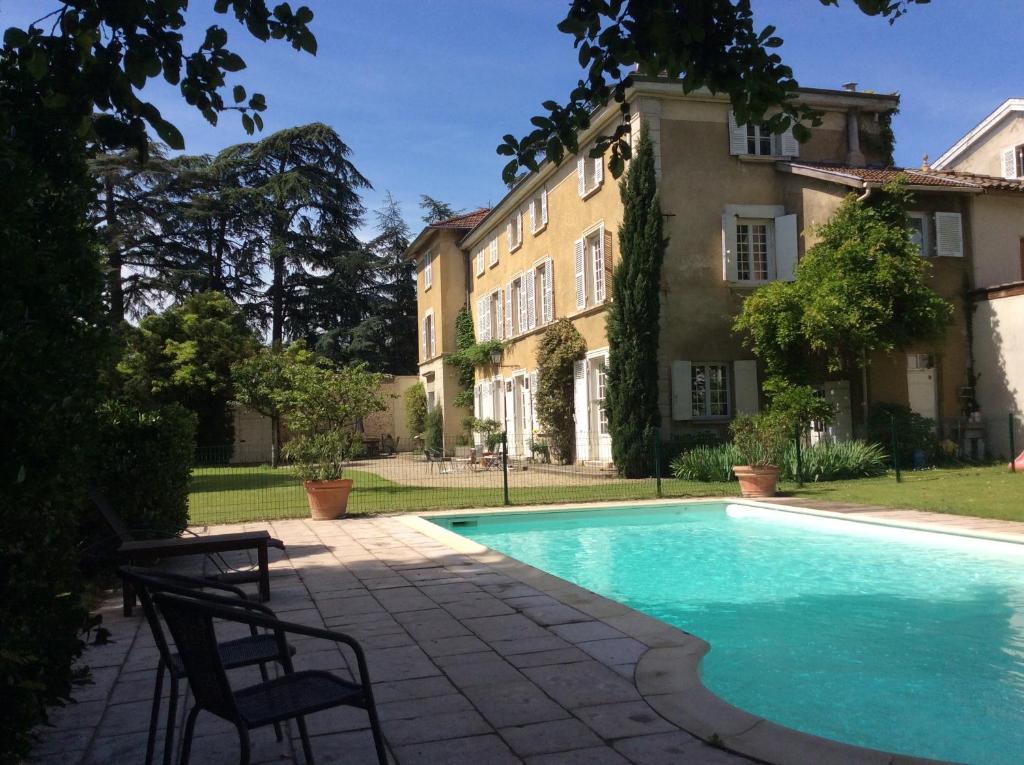 une piscine devant un immeuble dans l'établissement Le clos saint Genois, à Saint-Genis-Laval