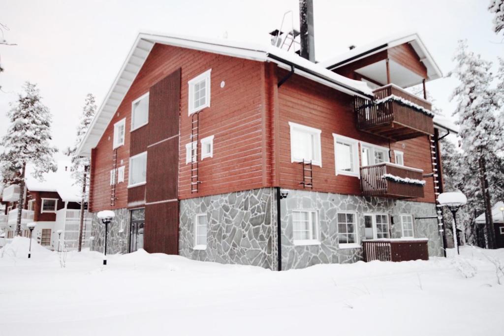 a large red brick building in the snow at Levillas Skimbaajankuja 6 as3 in Levi