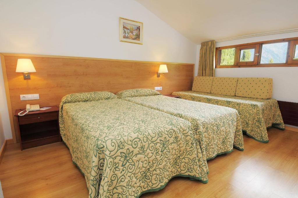 Postel nebo postele na pokoji v ubytování Evenia Monte Alba