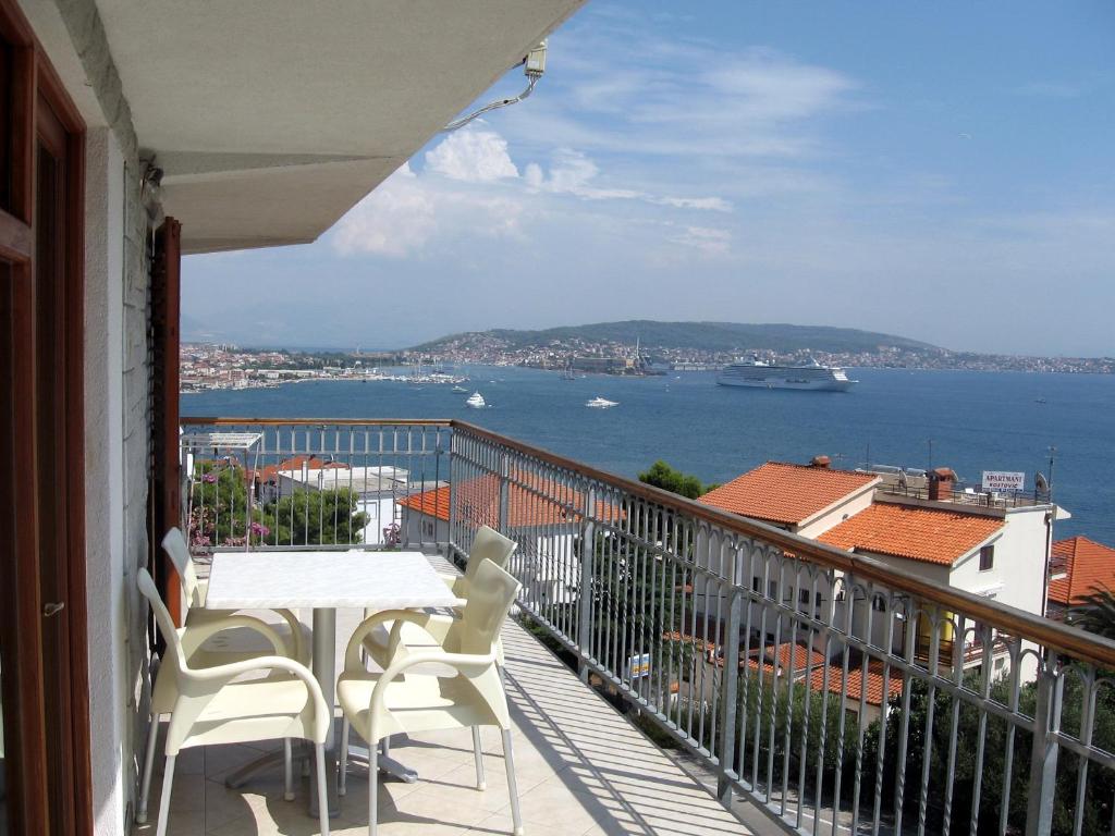 a balcony with a table and chairs and a view of the water at Apartment with splendid sea view in Trogir