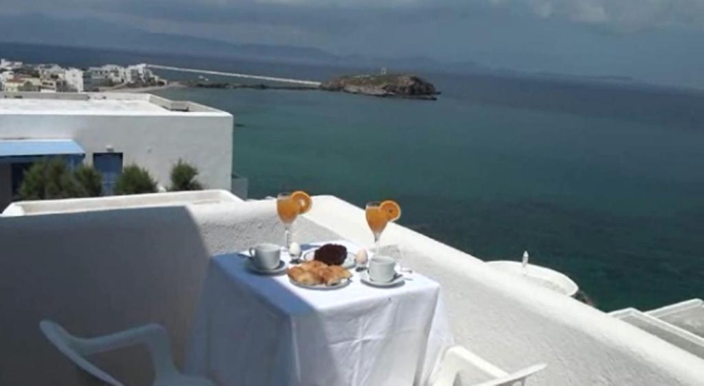 a table with a plate of food on top of a building at Magic View in Naxos Chora