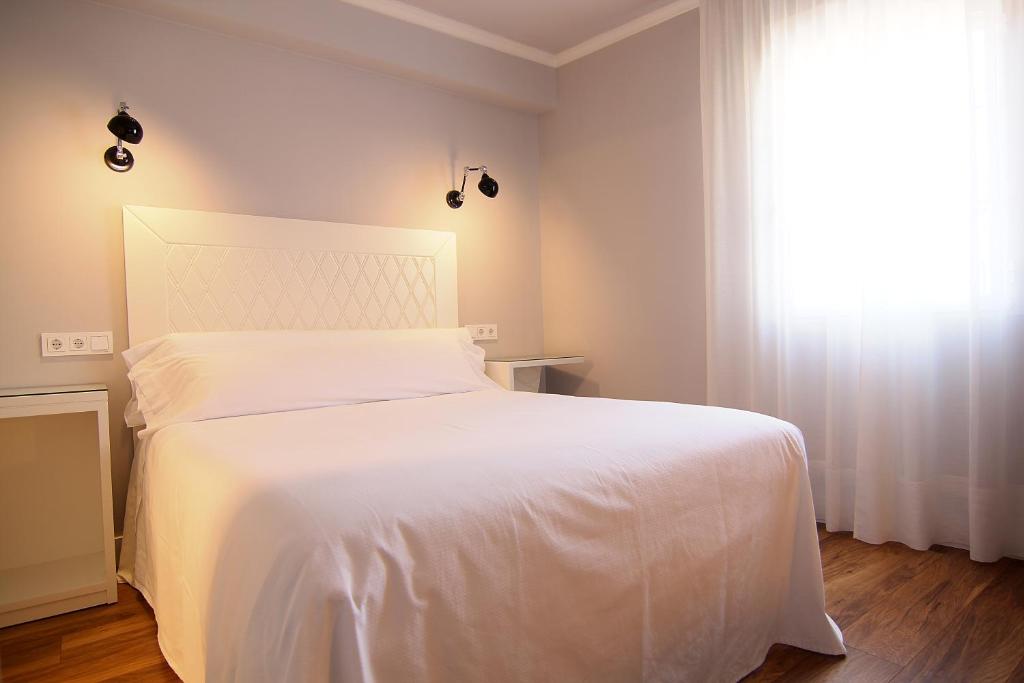 Postel nebo postele na pokoji v ubytování Hostal Los Castañuelos
