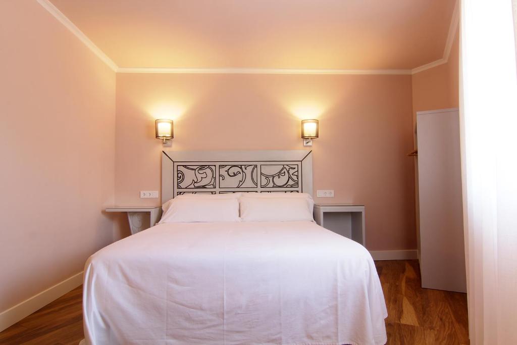 Postel nebo postele na pokoji v ubytování Hostal Los Castañuelos
