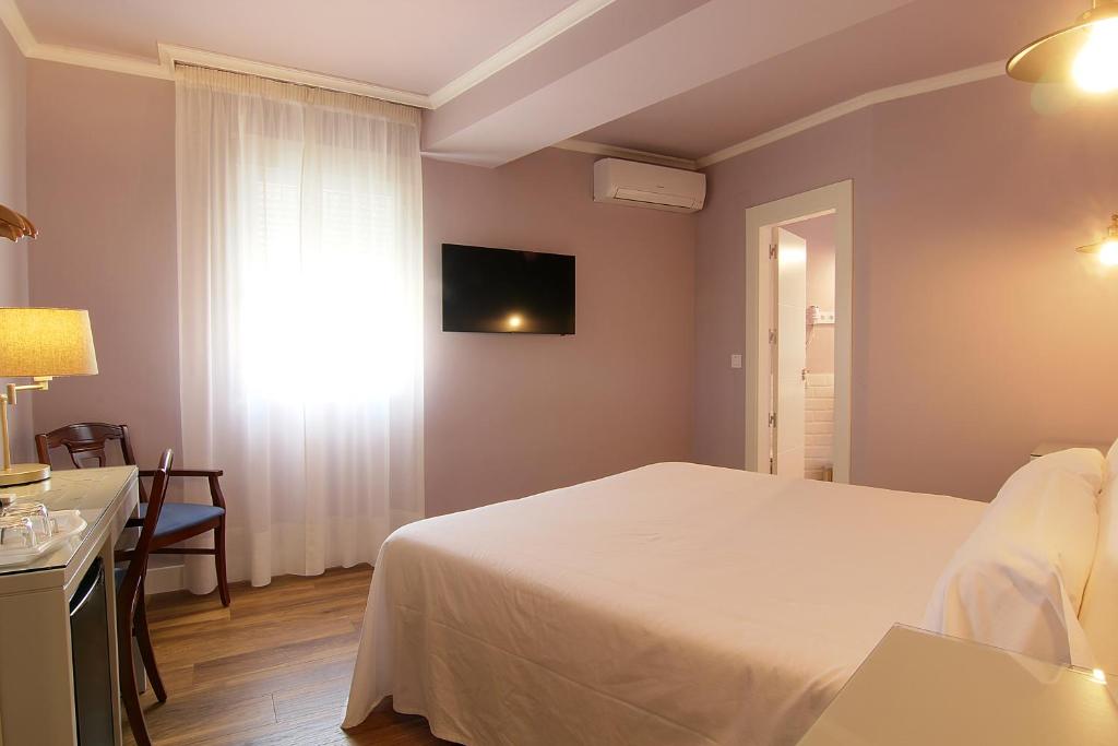 Postel nebo postele na pokoji v ubytování Hostal Los Castañuelos