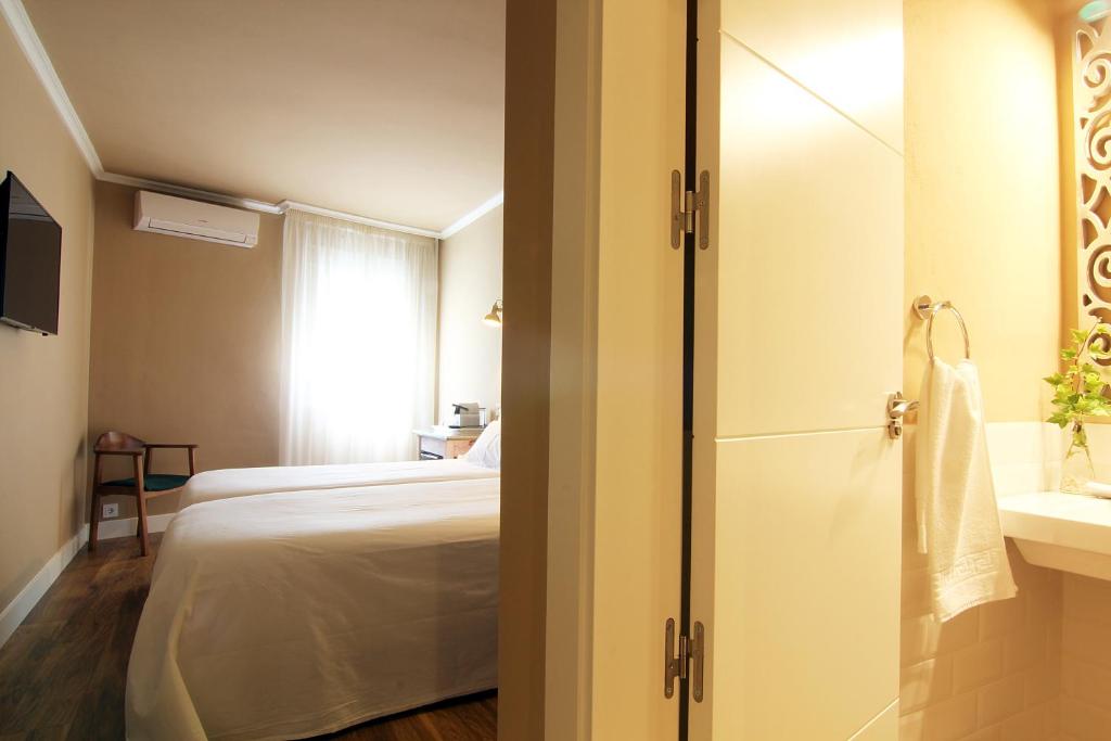 Postel nebo postele na pokoji v ubytování Hostal Los Castañuelos
