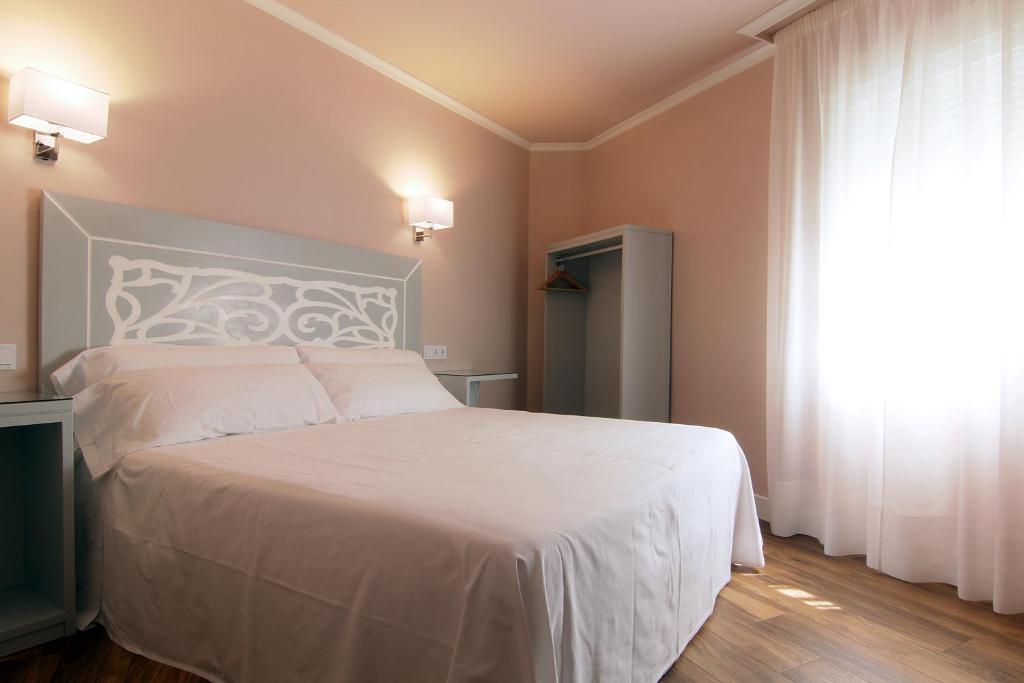Postel nebo postele na pokoji v ubytování Hostal Los Castañuelos