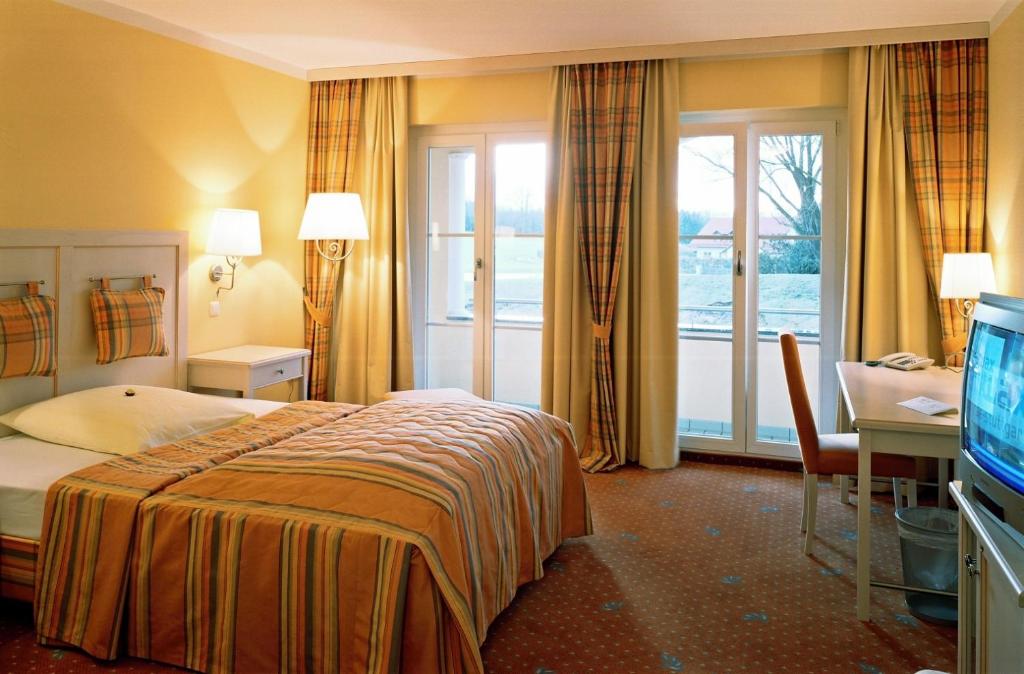 Postel nebo postele na pokoji v ubytování Ampervilla Hotel