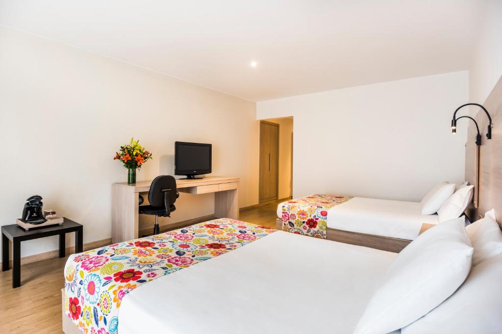 Postel nebo postele na pokoji v ubytování Hotel Rosales Plaza