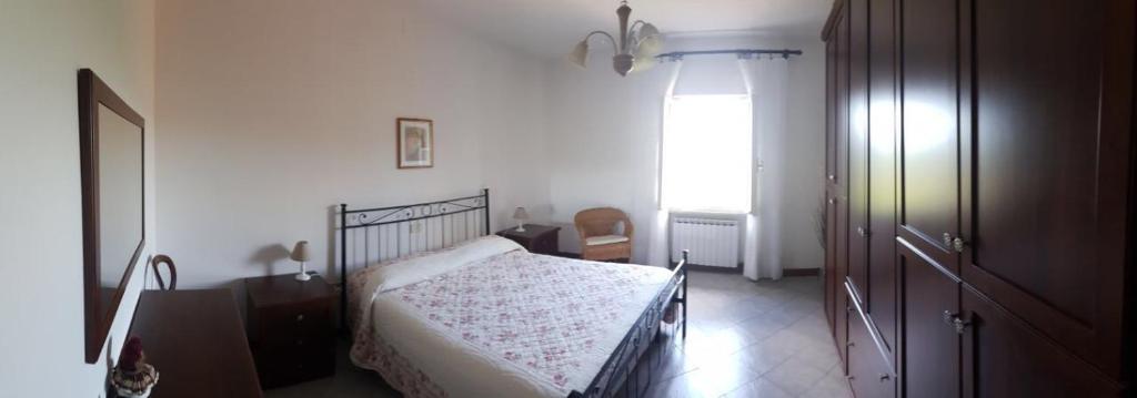 Schlafzimmer mit einem Bett und einem Fenster in der Unterkunft Casa Stefania in Lorano