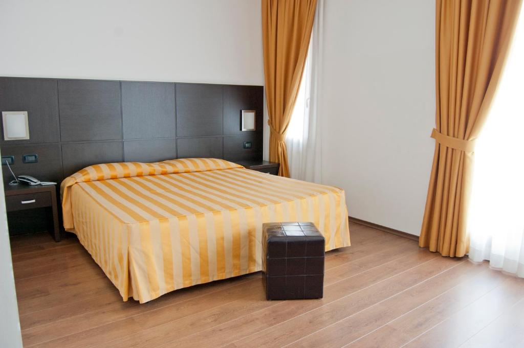 Postel nebo postele na pokoji v ubytování Hotel Leon Bianco