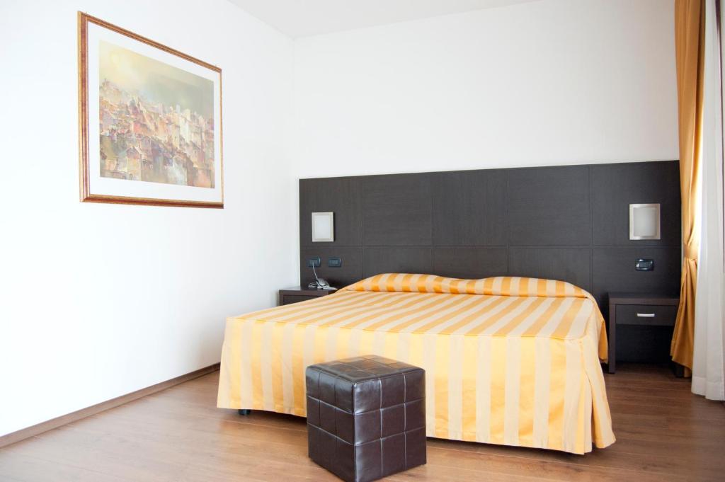 Postel nebo postele na pokoji v ubytování Hotel Leon Bianco