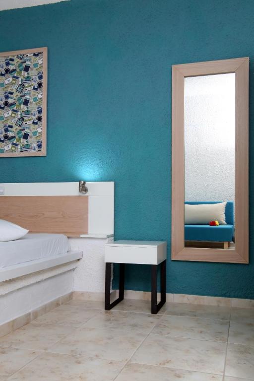 A bed or beds in a room at Ermioni Apartments