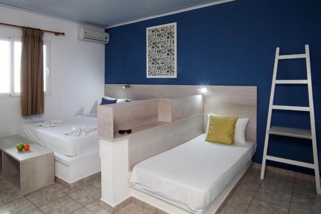 A bed or beds in a room at Ermioni Apartments