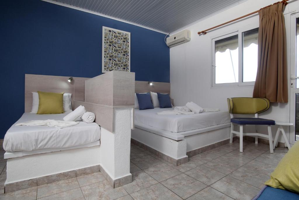 A bed or beds in a room at Ermioni Apartments