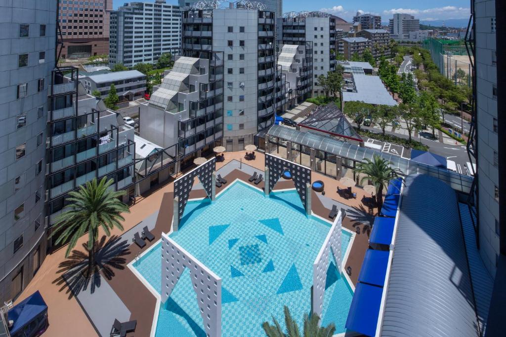 an overhead view of a swimming pool in a city at The Residential Suites Fukuoka in Fukuoka