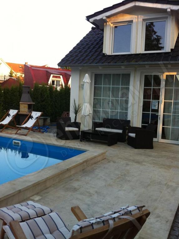 a backyard with a swimming pool and a house at Rewa in Rewal