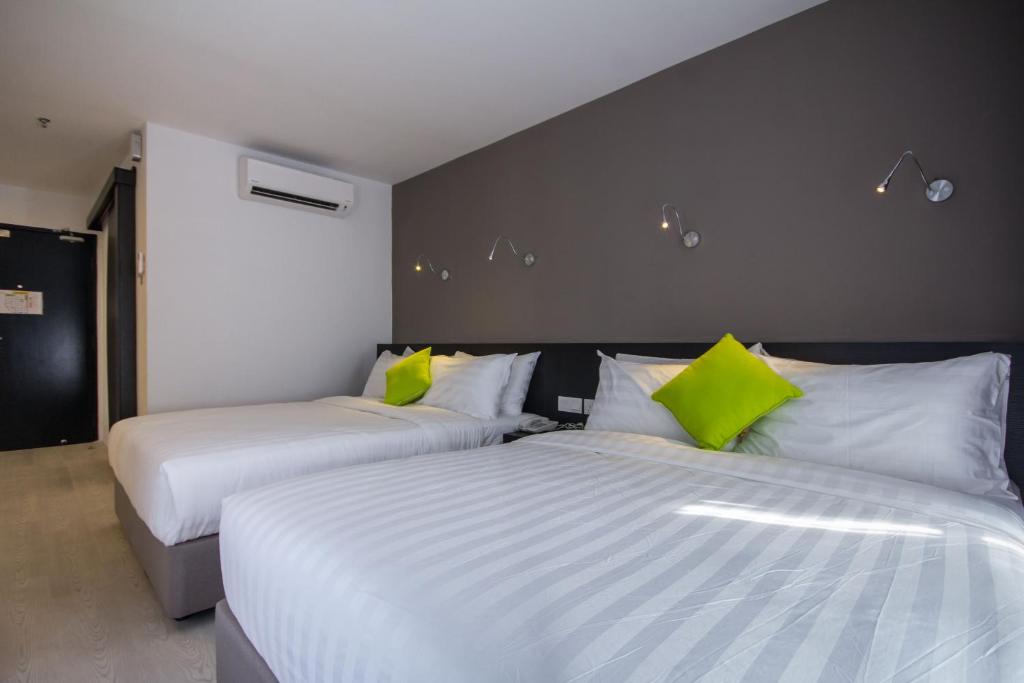 Postel nebo postele na pokoji v ubytování Manhattan Hotel Ipoh