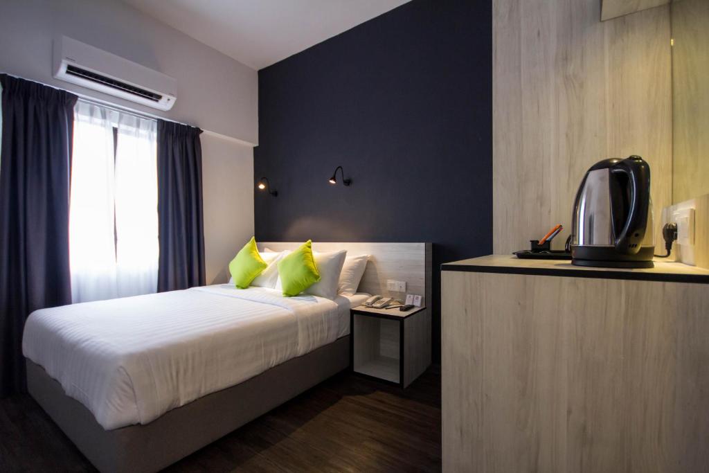 Postel nebo postele na pokoji v ubytování Manhattan Hotel Ipoh