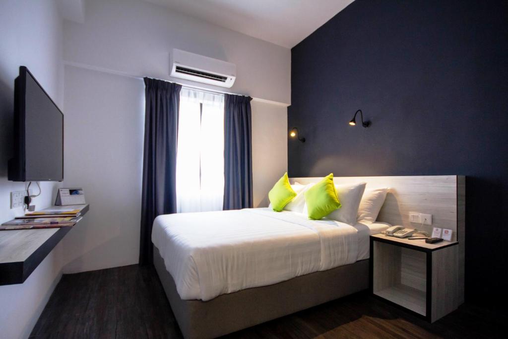 Postel nebo postele na pokoji v ubytování Manhattan Hotel Ipoh