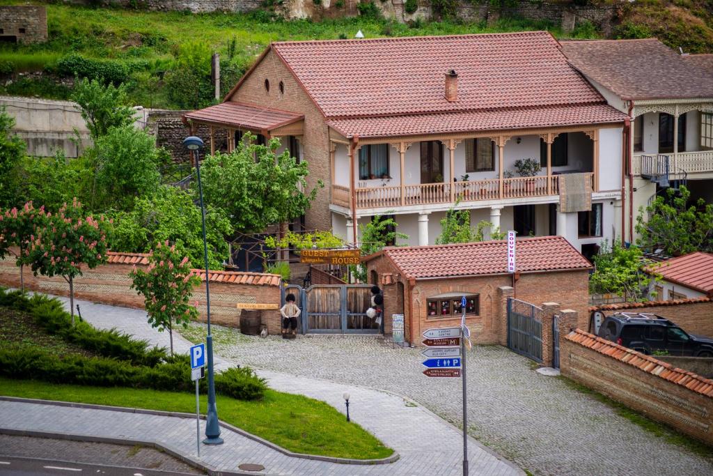 a large house with a street sign in front of it at GNG Guest House in Telavi