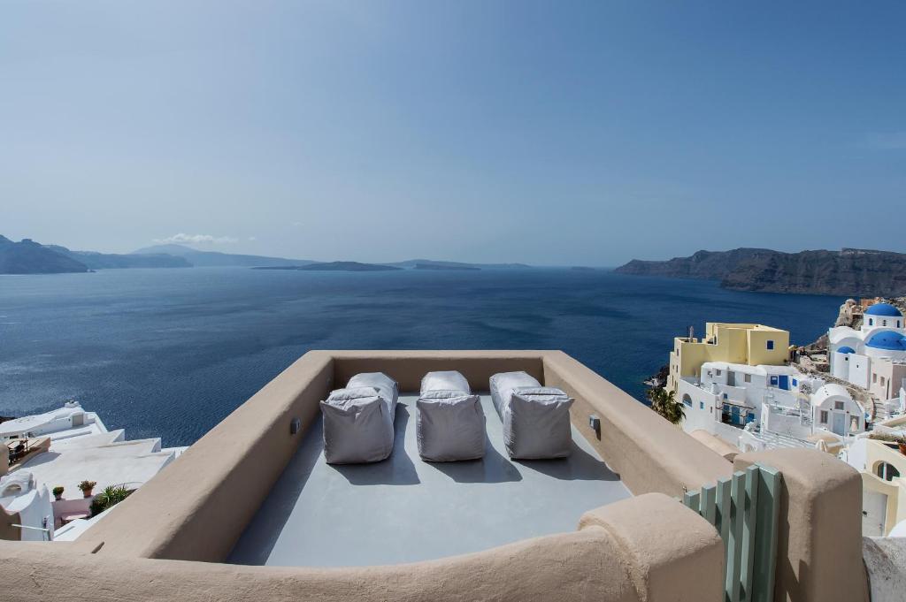 a view of the ocean from the rooftop of a house at Ammos Oia Mansion in Oia