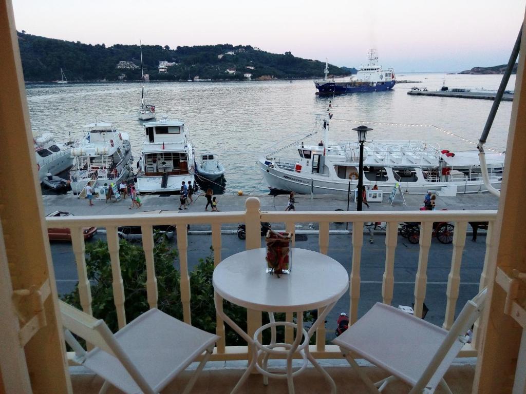 a balcony with a view of a marina with boats at Skiathos city views studios-apartments in Skiathos Town