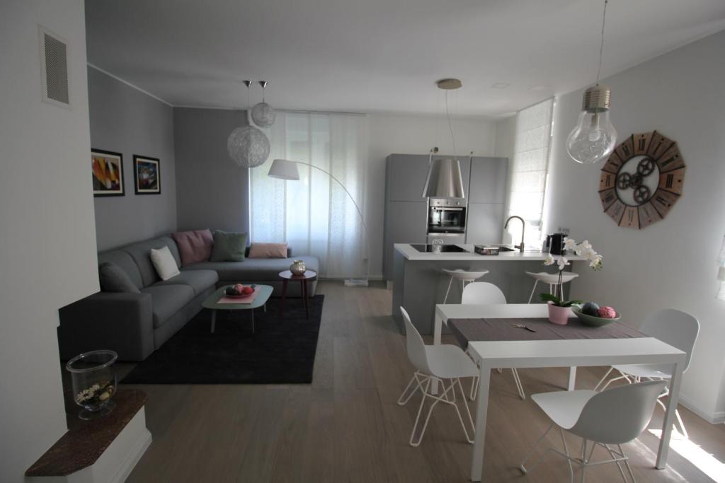 a living room and kitchen with a couch and a table at Apartman Stoosova Deluxe in Zagreb