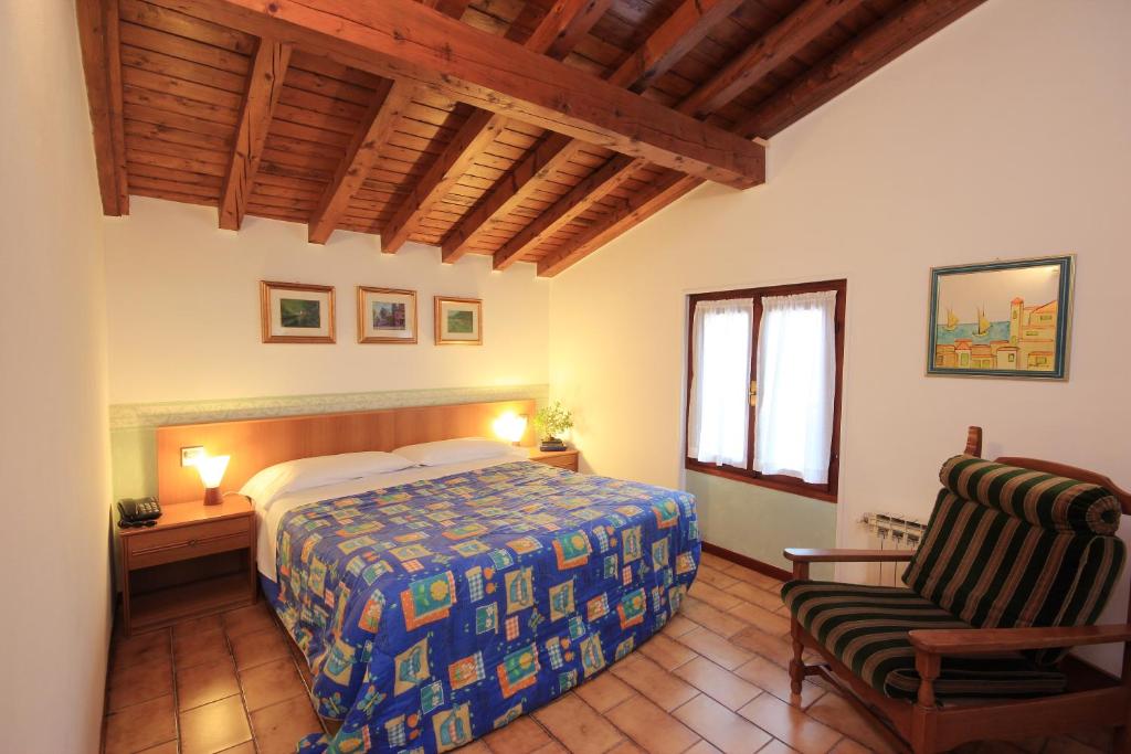 Postel nebo postele na pokoji v ubytování Hotel Colomber