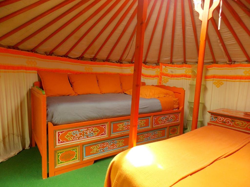 1 dormitorio con 2 camas en una yurta en Yourte mongole, en Huriel