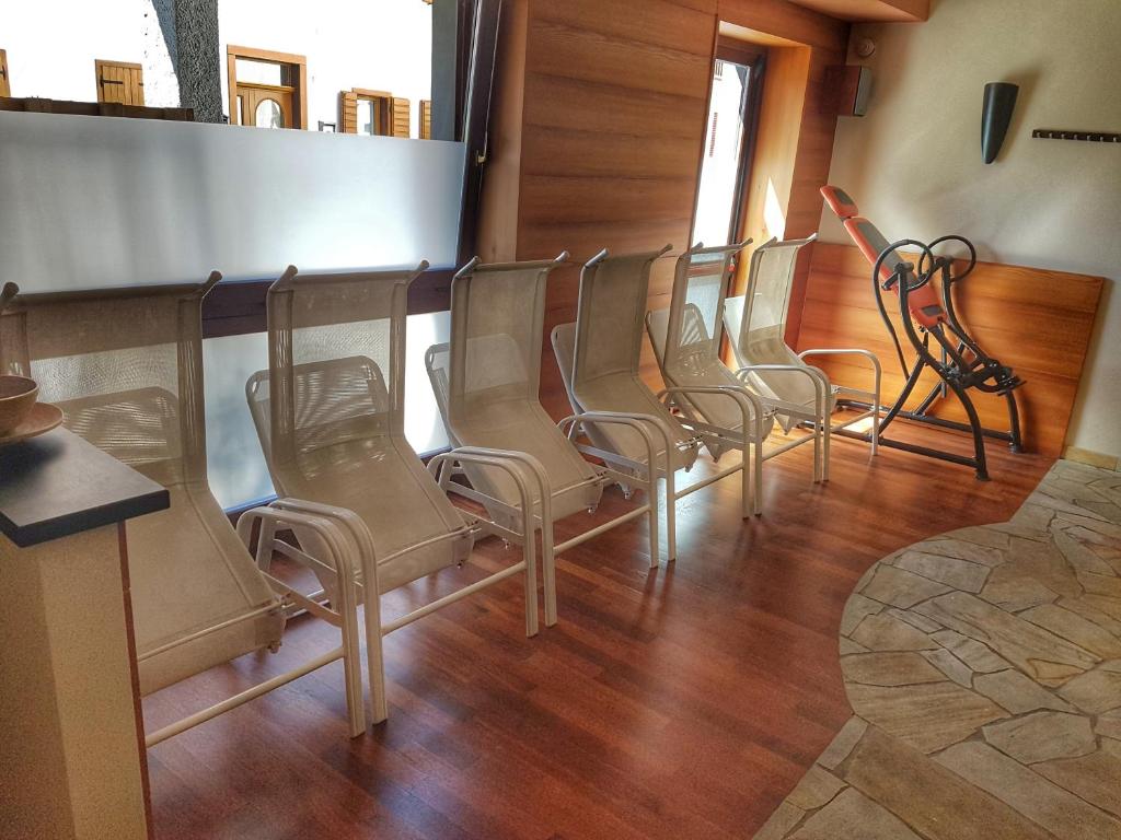 a row of chairs sitting in a waiting room at Hotel Centrale in Auronzo di Cadore
