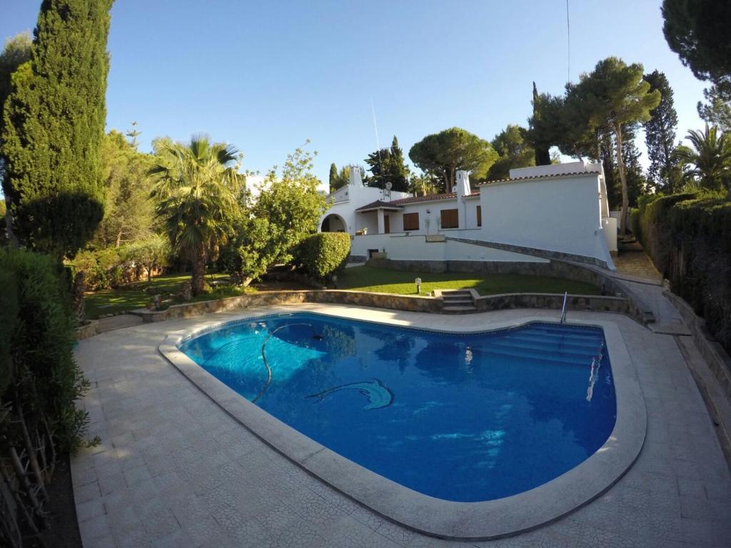 a swimming pool in front of a house at Villa mediterránea en Roc de Sant Gaietà in Roda de Bará