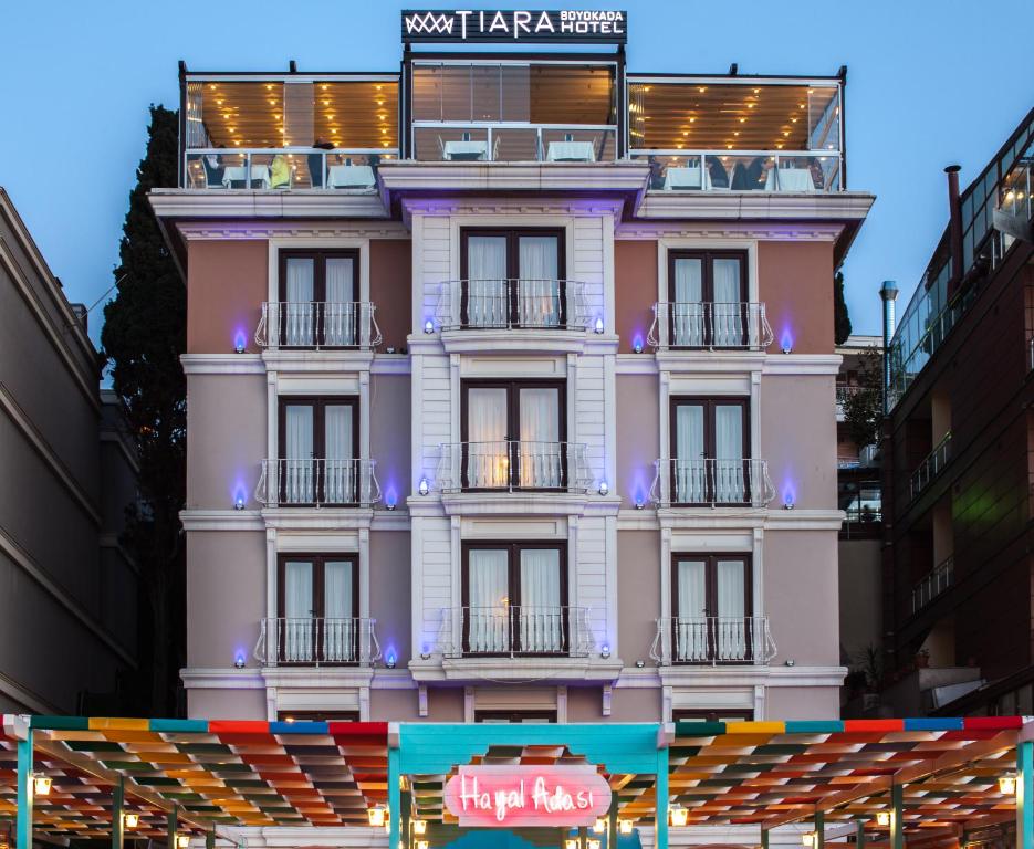 a pink building with a sign on it at Tiara Buyukada in Buyukada