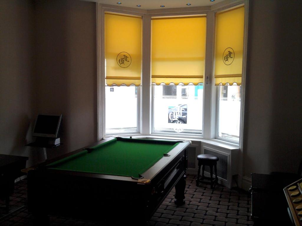 a pool table in a room with a window at Fairway Hotel in Blackpool