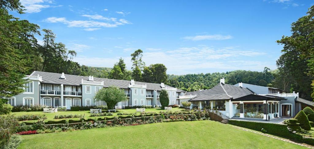 an exterior view of a large house with a yard at Jetwing St Andrew's in Nuwara Eliya