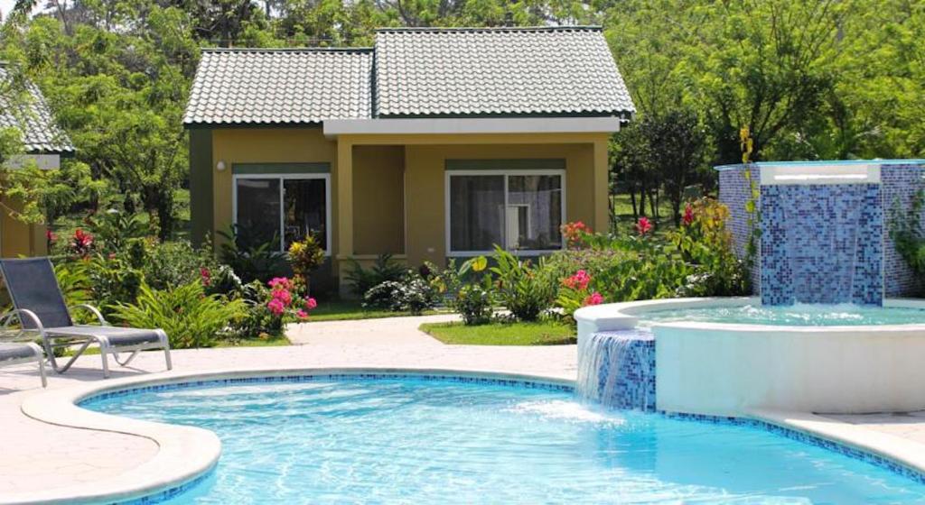 a home with a swimming pool and a house at Dream Away Corinto in La Ruidosa