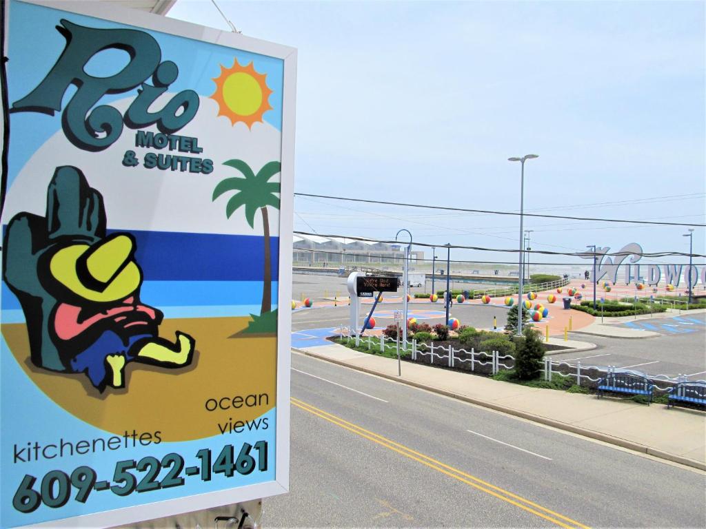 a sign for a hotel and suites on the side of a road at Rio Motel and Suites in Wildwood