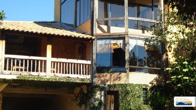 a large building with a porch and a balcony at D'Elber Pousada in Serra do Cipo
