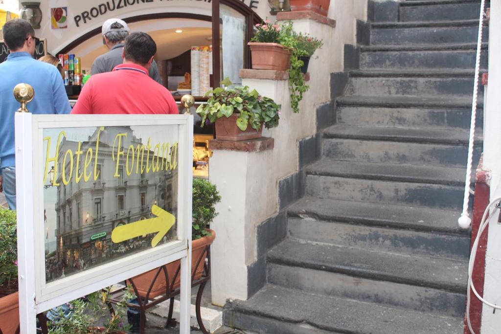 a set of stairs with a sign in front of a store at Hotel Fontana in Amalfi