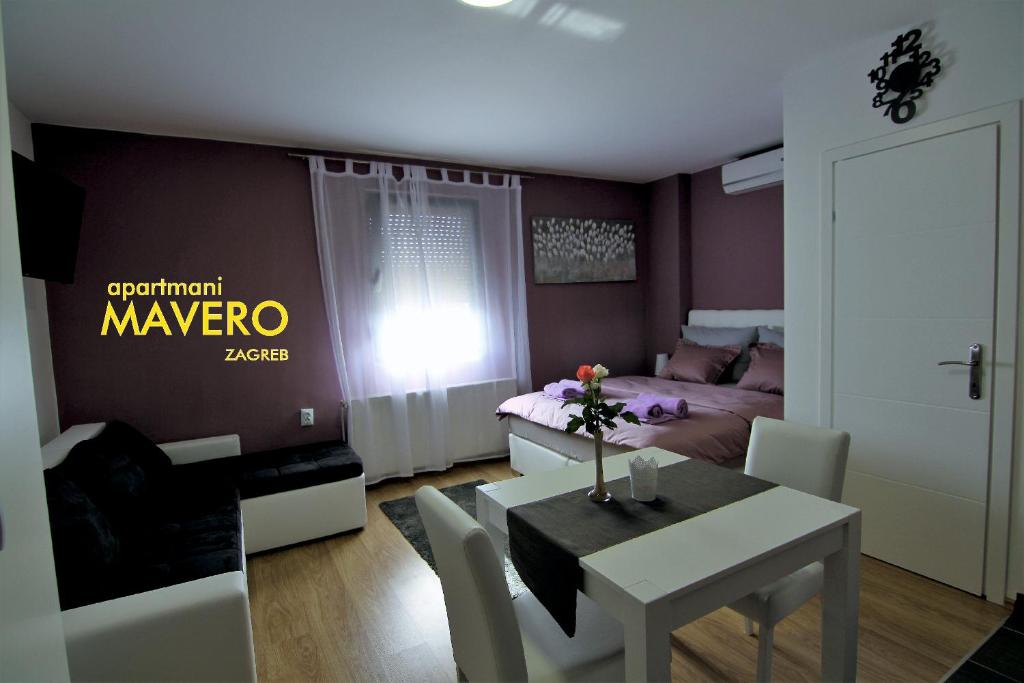 a living room with a dining table and a bedroom at Apartment Mavero-Free Private Parking in Zagreb