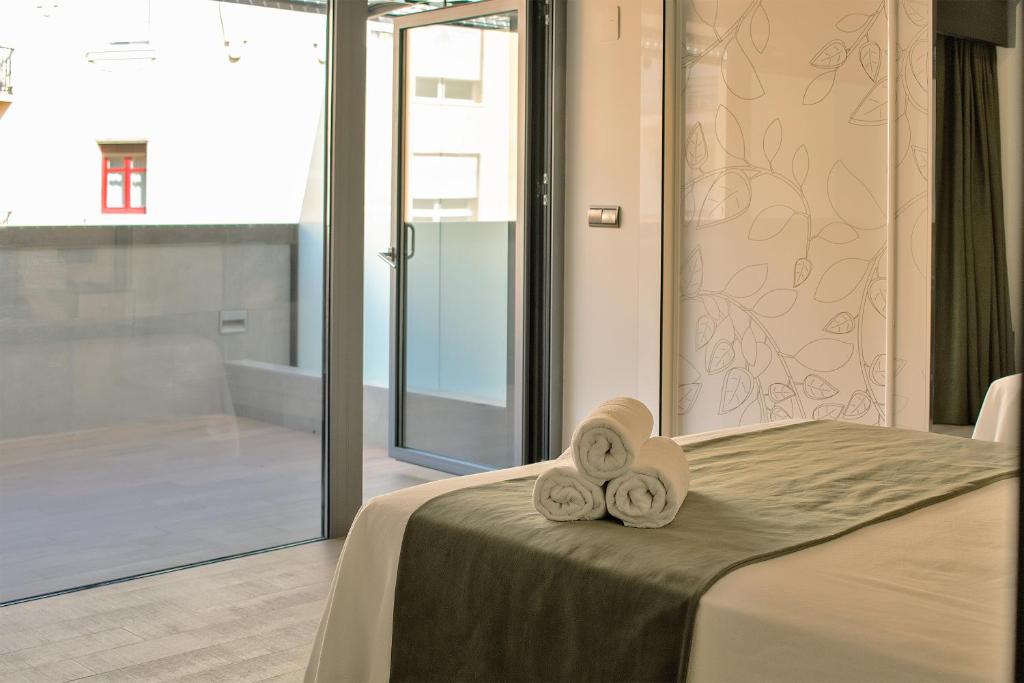 Posteľ alebo postele v izbe v ubytovaní Apartamentos Suites Oficentro Deluxe