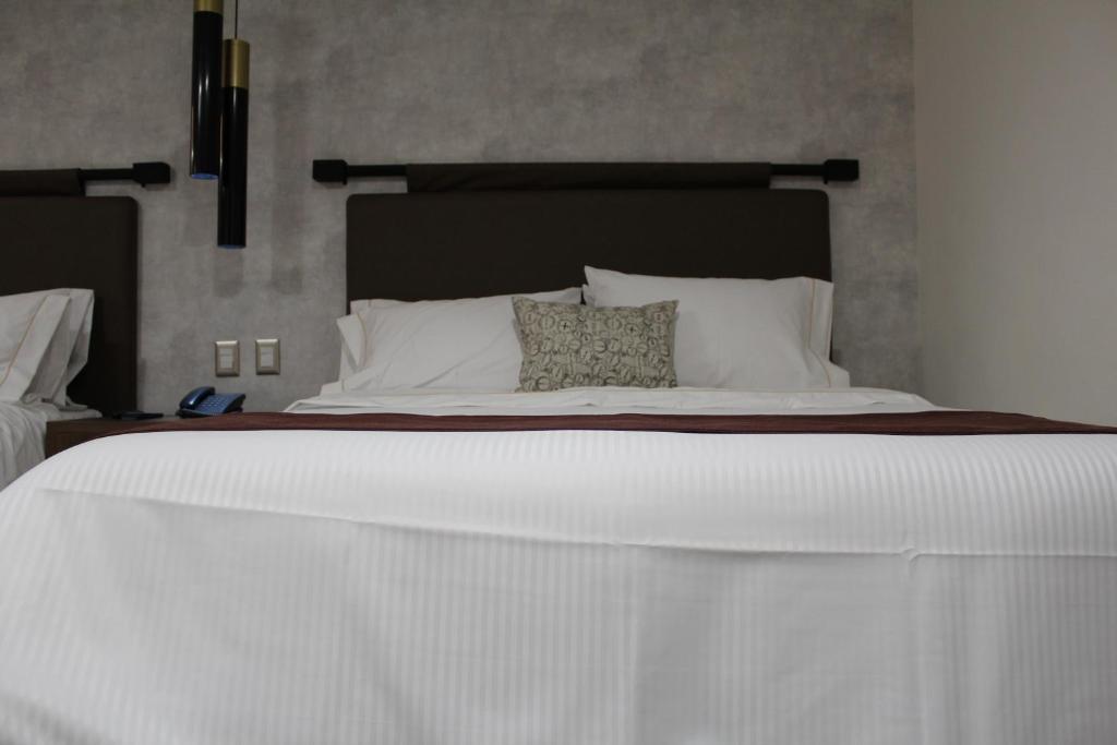Postel nebo postele na pokoji v ubytování Hotel Ronda Minerva